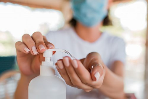 Woman applying hand sanitizer to help against the spread of coronavirus.