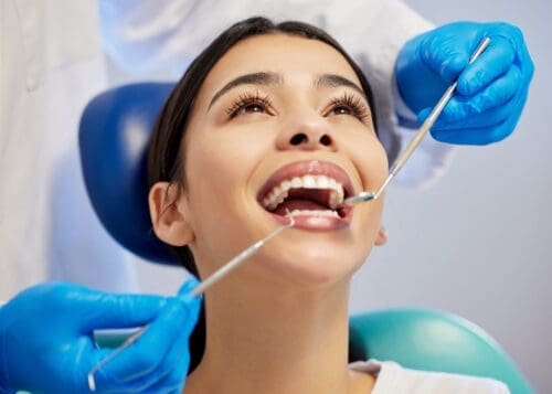 Dental patient smiling during exam - City Creek Dental