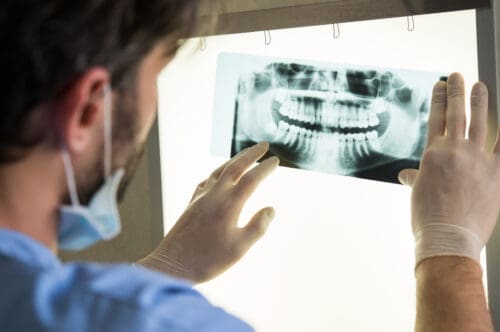 Dentist looking at dental xray - City Creek Dental