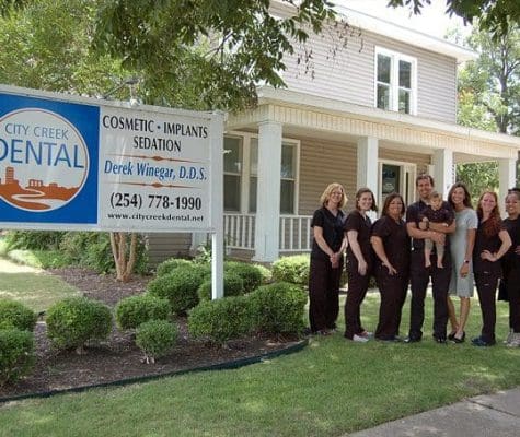 City Creek Dental Staff portrait, outside, with clinic background.